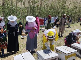 beneficiaries receiving bee keeping training 